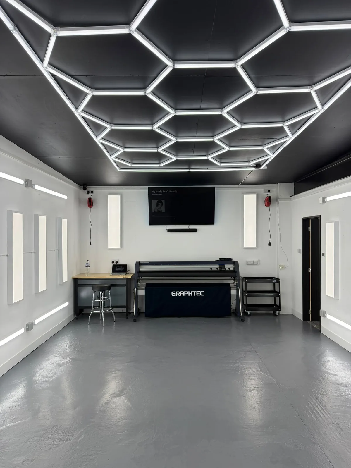Inside OnPoint's Southampton detailing studio with ceiling and wall lighting